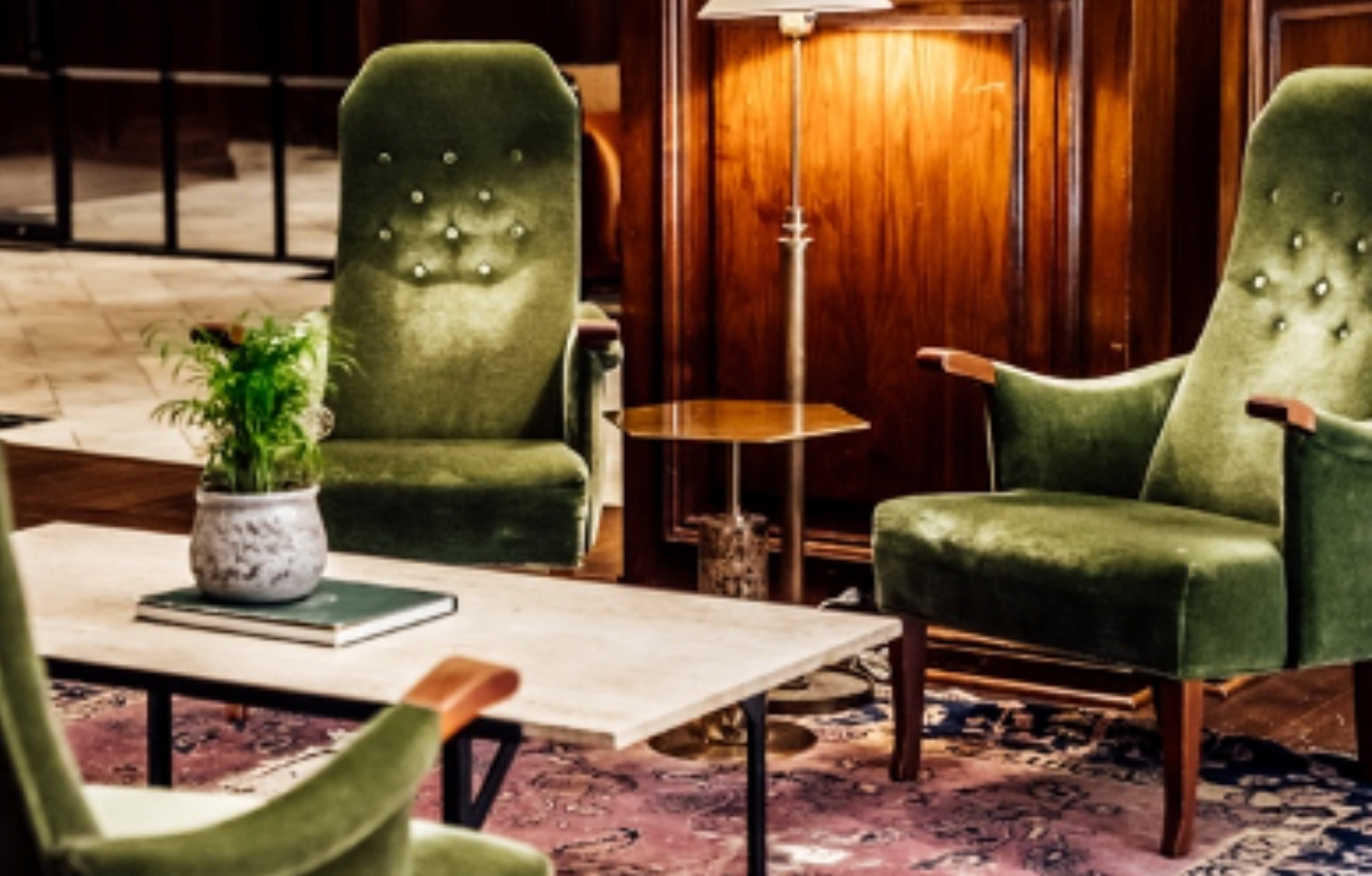 Seating area with green chairs and a coffee table