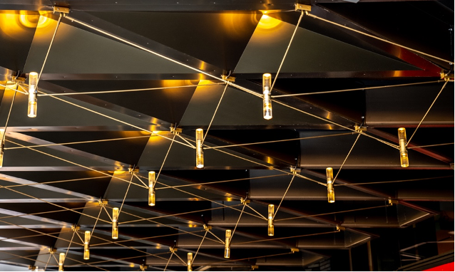 A black ceiling with multiple light fixtures