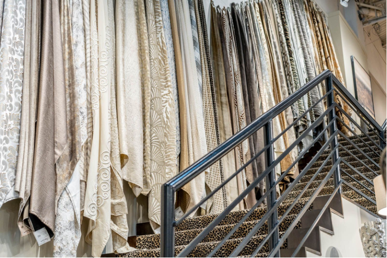 A staircase with fabrics hanging on the wall along the stairs