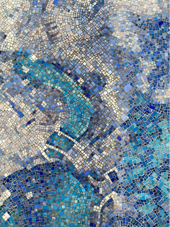 A mosaic design of different blue tiles