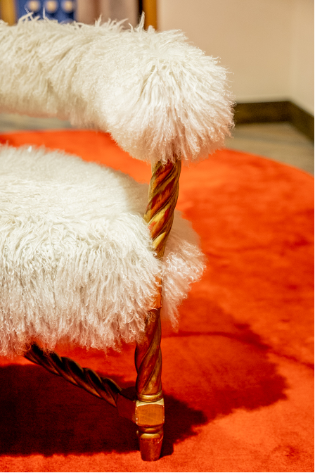 A fluffy chair on an orange rug